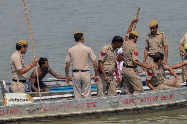 Goddess Durgas Immersion in River Yamuna, New Delhi, India-September 30, 2017: Delhi Police officials on a motor boat doing their duties at Kalindi Kunj, New Delhi.