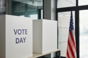 Voting booth setup with American flag, symbolizing election day.
